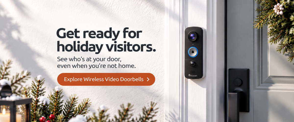 Toucan UK wireless video doorbell with built-in camera and blue-ring bell button, mounted beside a festive front door.